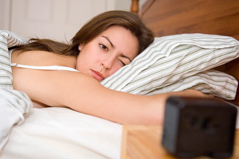 1800x1200 sleepy woman in bed looking at clock other