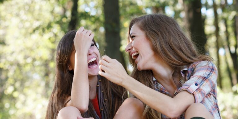happy teen girls outdoors laughing