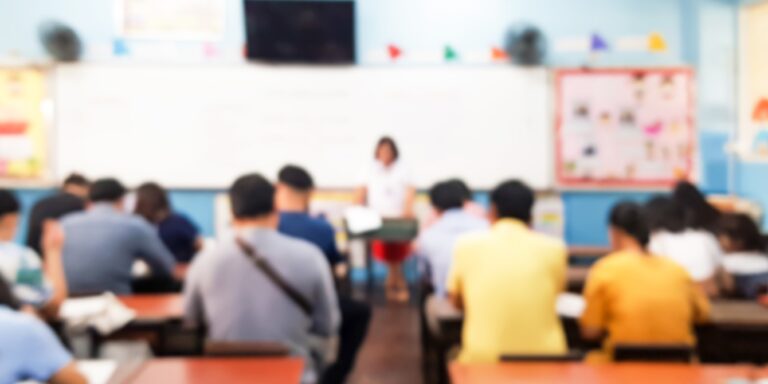 Blurred images of parents sitting in the classroom