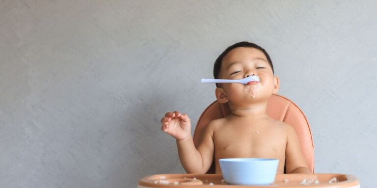 introducing solids baby eating with spoon